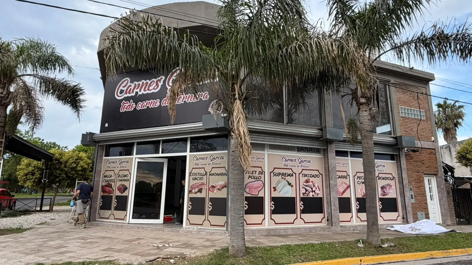 Vista de la esquina de Carnes García con el cartel y las vidrieras gráficas